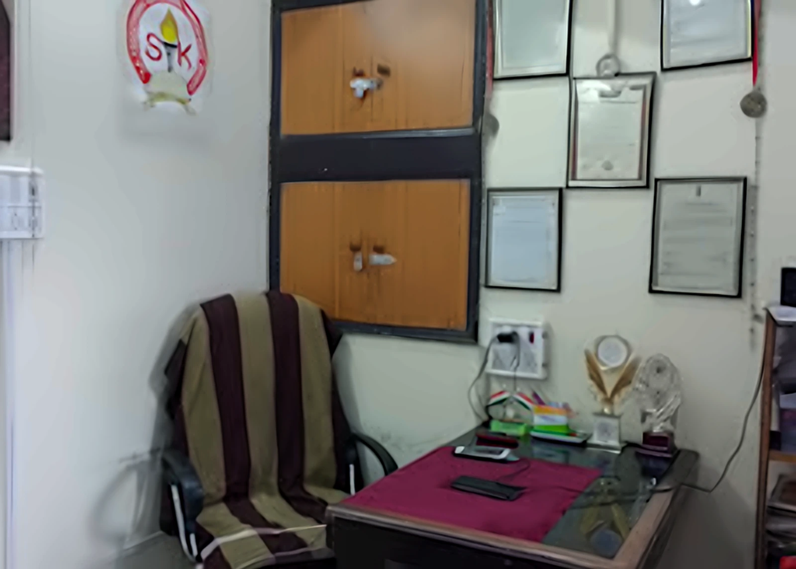 SK Institute founder's office with framed certificates and recognitions