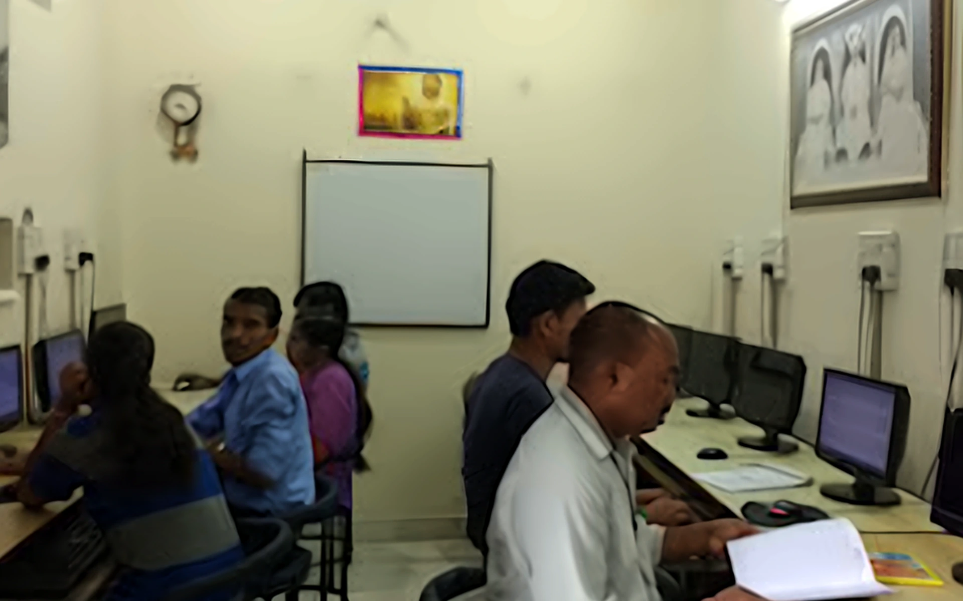 Faculty guiding students in the computer lab at SK Institute, Mangolpuri